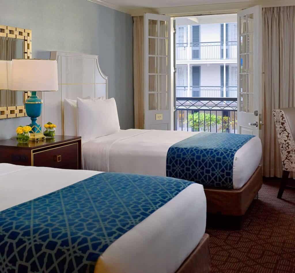 Spacious guestroom with two double beds, ideal for a relaxing stay.