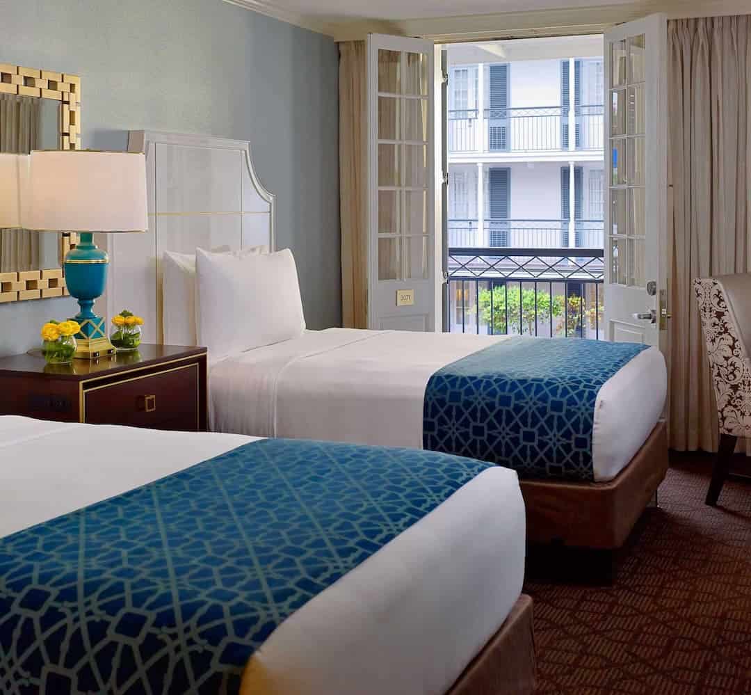 Spacious guestroom with two double beds, ideal for a relaxing stay.