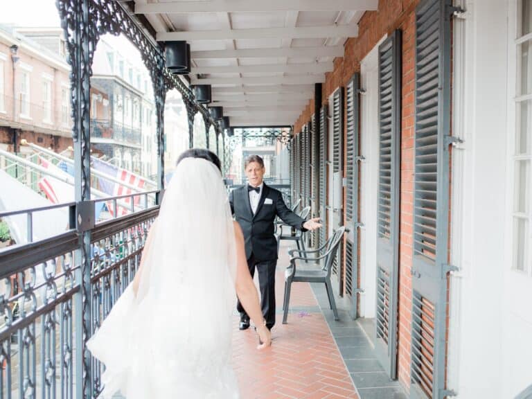 Two people walking towards each other on a scenic balcony of RS New Orleans.