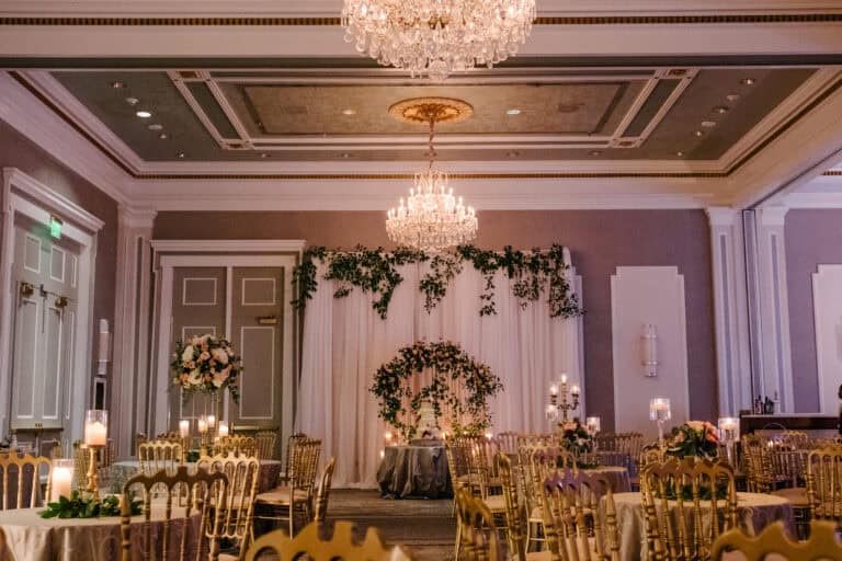 Wedding setup featuring floral arrangements and luxurious ballroom details.