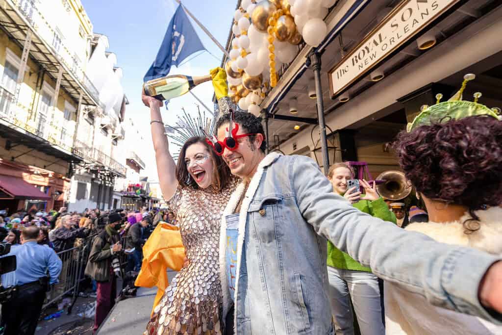 Two people taking a selfie on the streets of New Orleans during Mardi Gras.